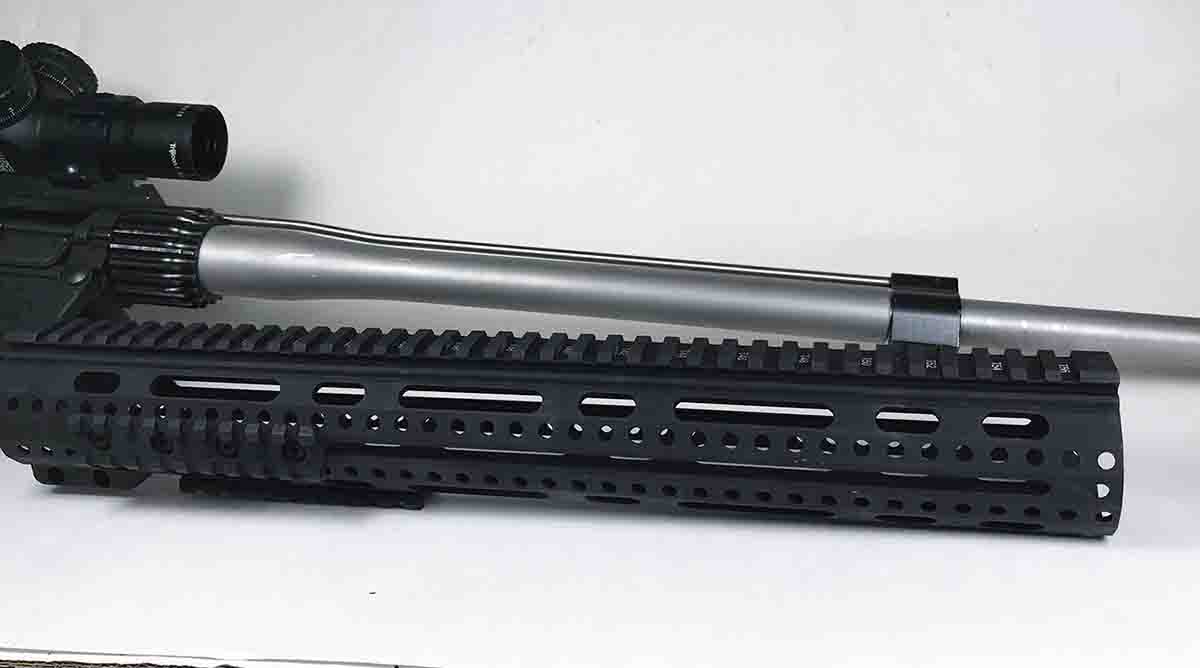 A free-floating handguard attaches to the upper by a barrel nut and clamps in place by tightening two screws.